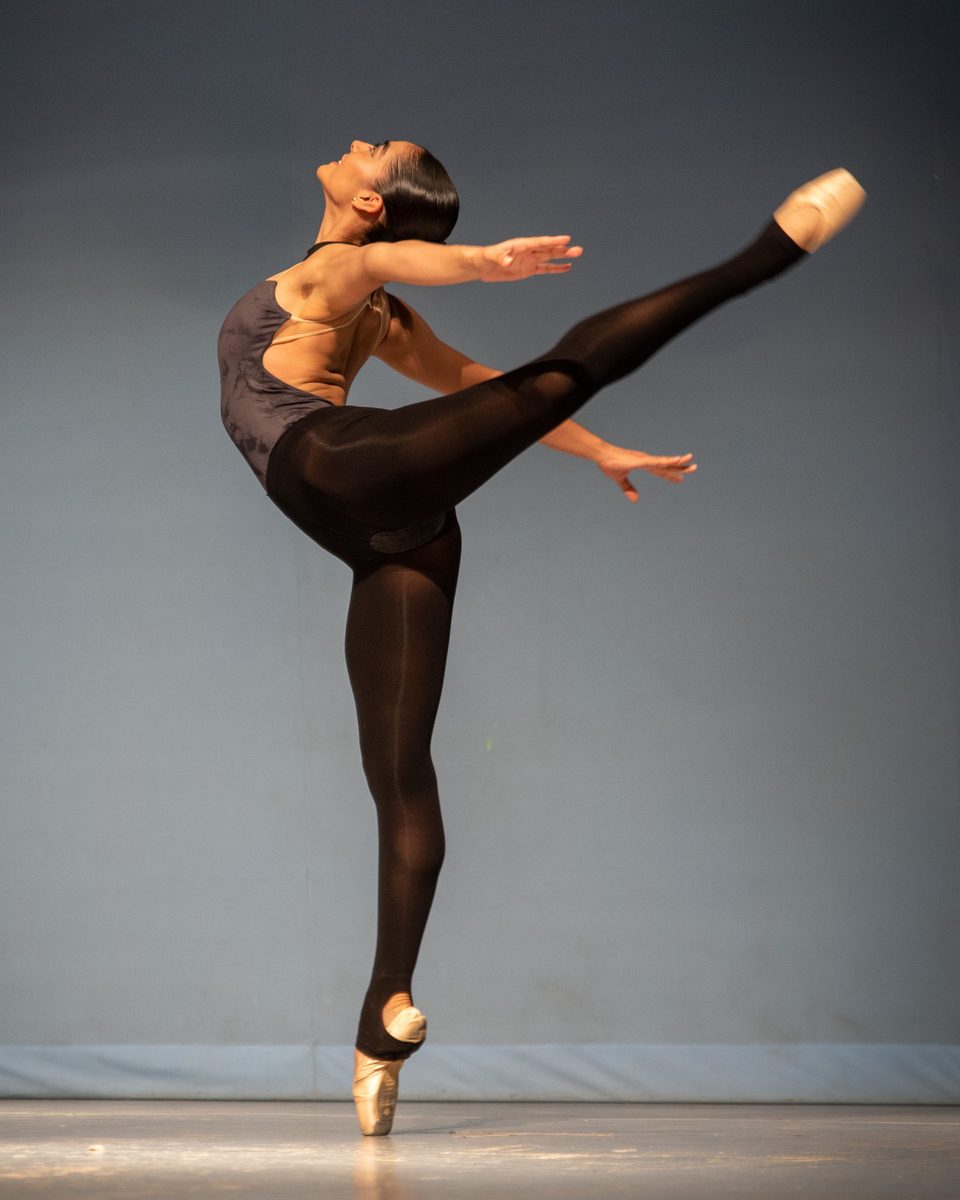 Ballet dancer en pointe in arabesque on stage